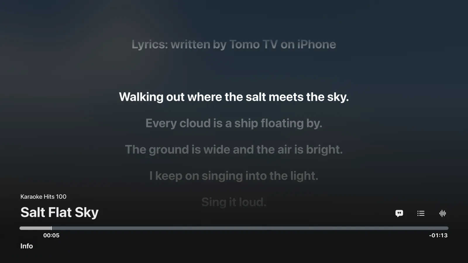 Tomo TV's music player on Apple TV with its controls up: the caption "Lyrics: written by Tomo TV on iPhone" over lyrics that fill the screen, the sung line in white and the lines below it dimmed, above the song's title and a progress bar