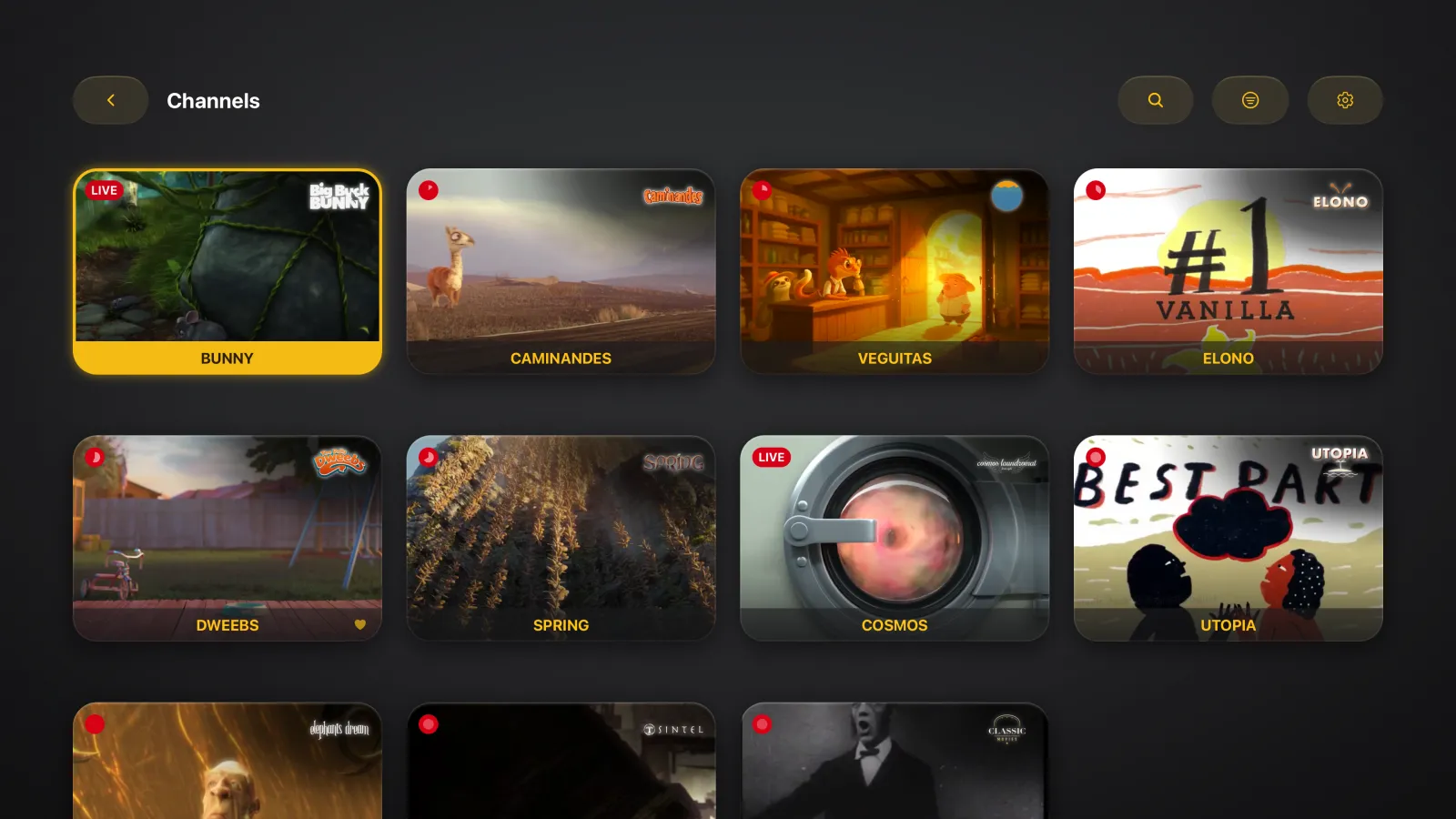 The Channels screen in Tomo TV on Apple TV, a grid of channel cards that each show a frame of what is on, with the first card focused