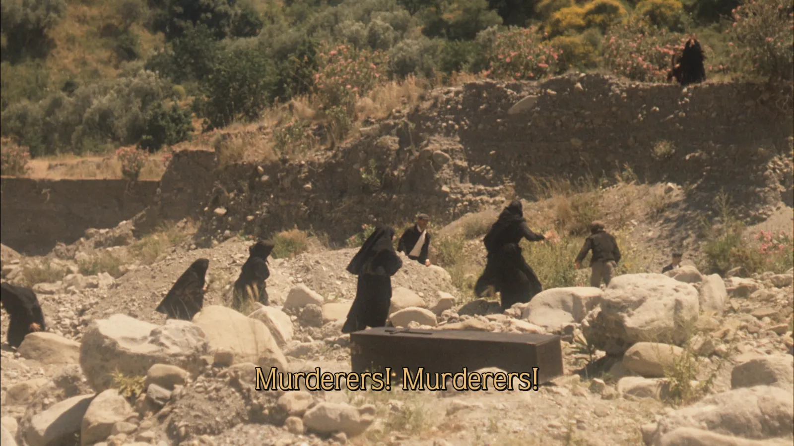 A yellow picture subtitle reading Murderers! Murderers! over a film playing in Tomo TV on Apple TV